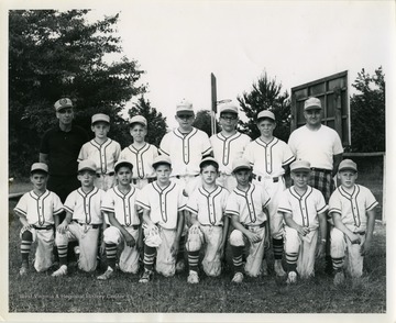 A photo of the 1964 Lions Little League baseball team with coach Bob Harrtey (right).