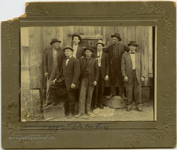 Troy Hatfield standing among a group of detectives.