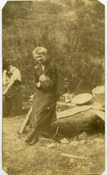 Polly Hatfield holding a dead raccoon.