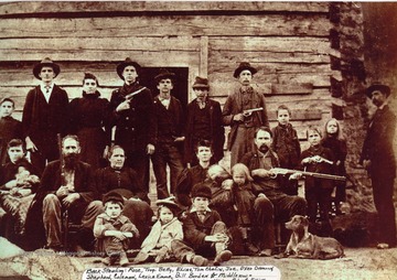 (back standing L to R); Rose, Troy, Betty, Elias, Tom Chafin, Joe, Oxer Damron, Shepard, Coleman, Levica Emma, and Bill Borden. (Middle row); Mary Howes, Vicie Simpkins, Devil Anse, Levicy, Nancy, Robert, Elliott, Louise, Cap. (Front row) Tennis, Midge, Willis, Old Yellow.